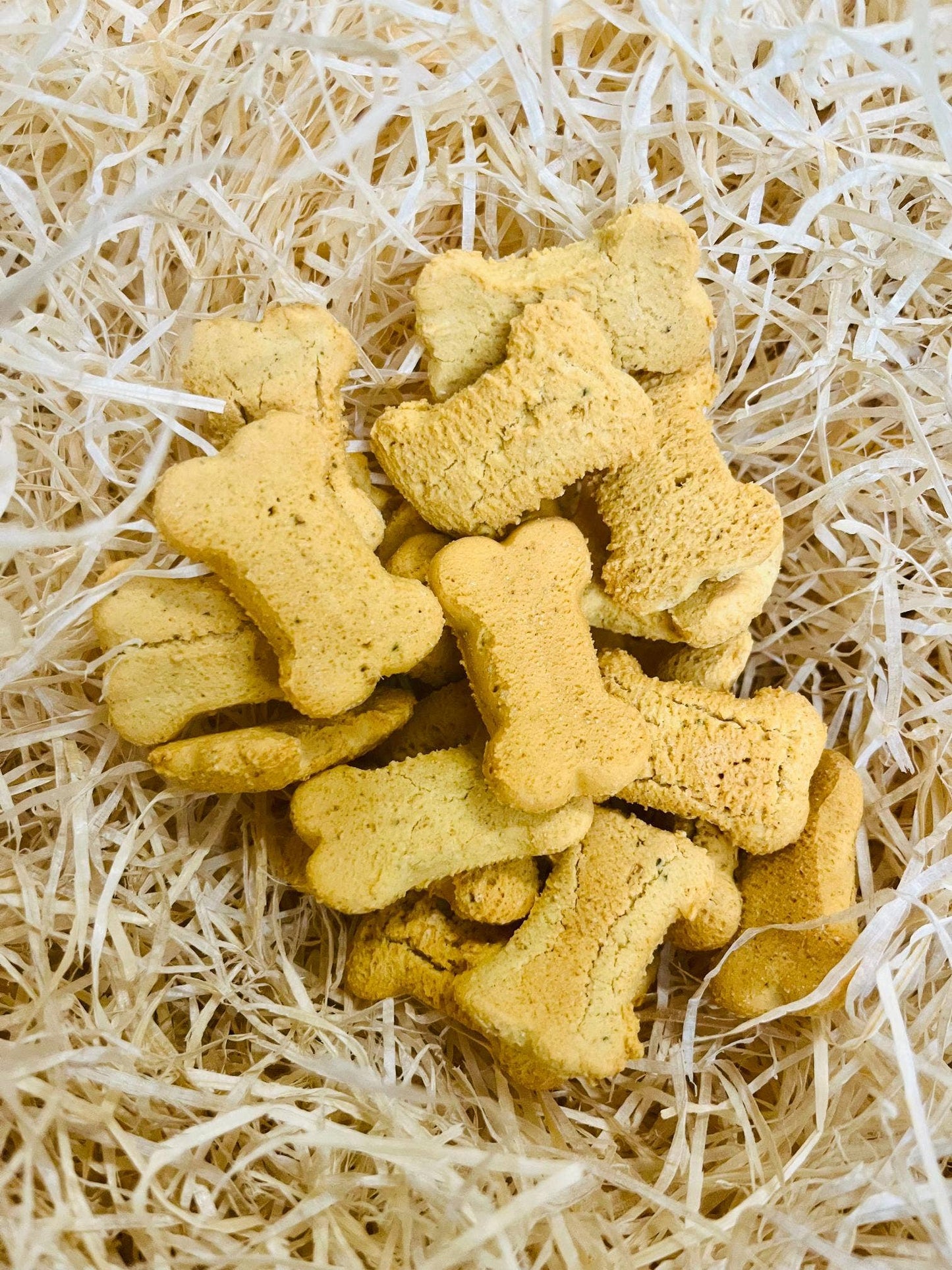 Bedtime Biscuits calming dog treats displayed loose, grain-free peanut butter biscuits with chamomile, valerian, and passion flower.
