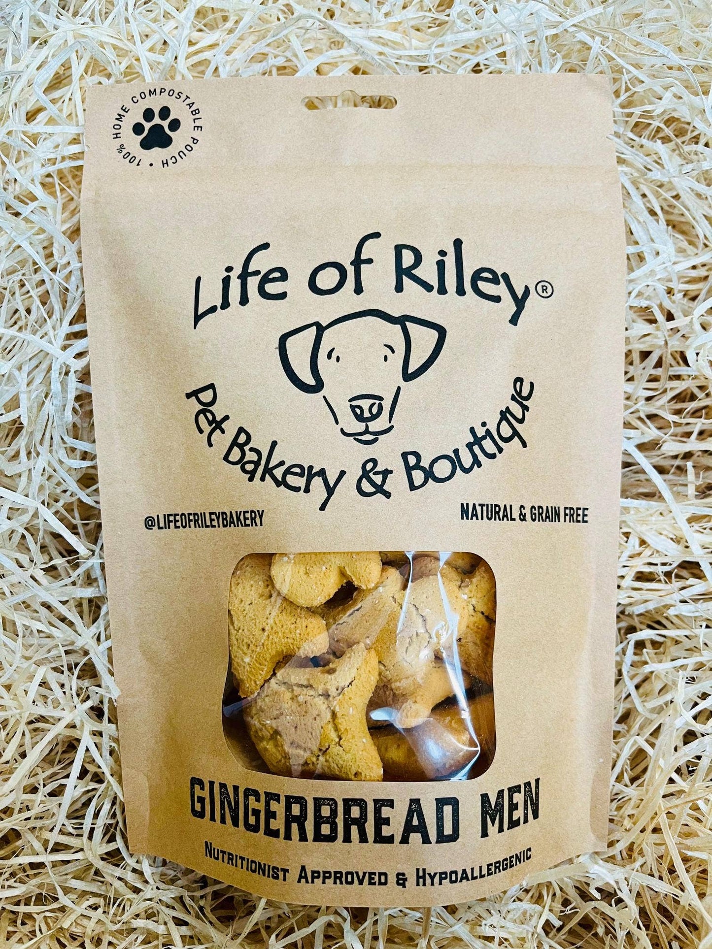 Mini Gingerbread Men dog treats in a retail pack, grain-free peanut butter and ginger biscuits for dogs.