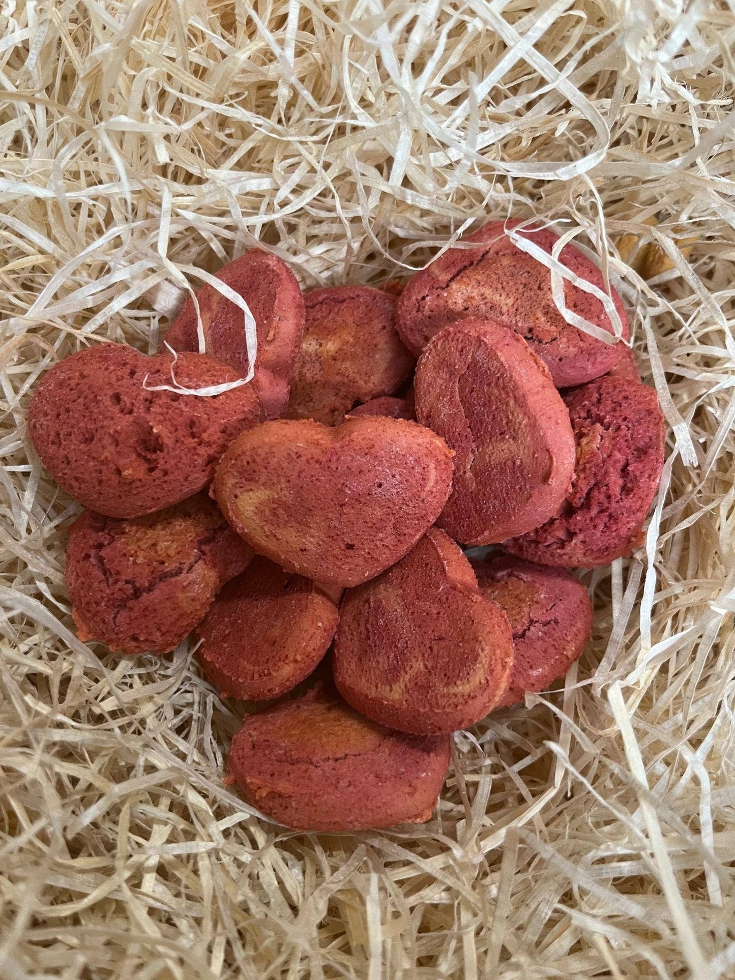 Heart shaped Beetroot Biscuits dog treats displayed loose, hand-baked crunchy biscuits made with peanut butter and beetroot.