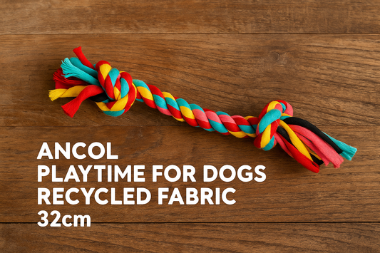 Flat-lay of medium Ancol Playtime multi-coloured dog rope toy made from recycled fabric on wooden surface with eco-style presentation