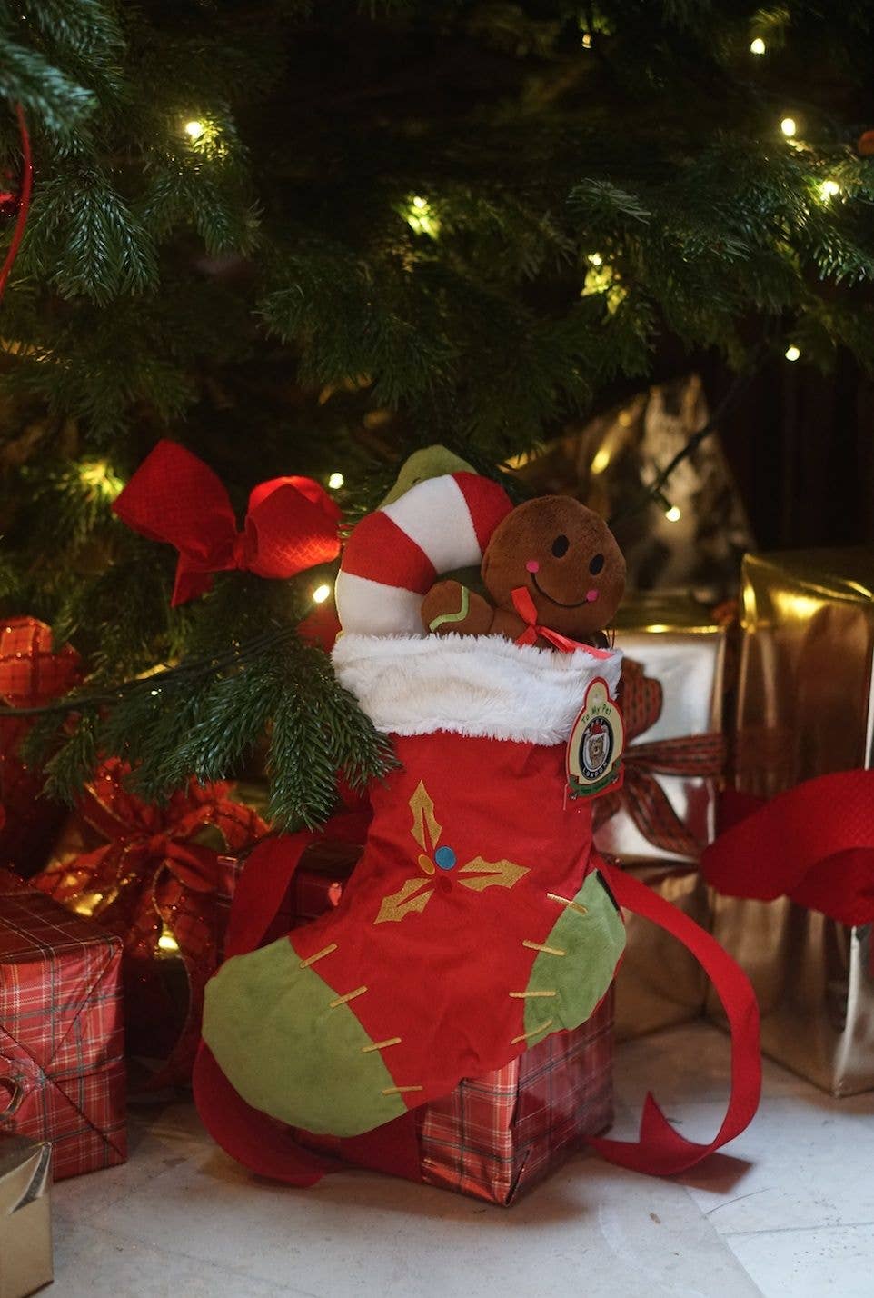 PetLondon dog Christmas stocking displayed under Christmas tree with wrapped presents